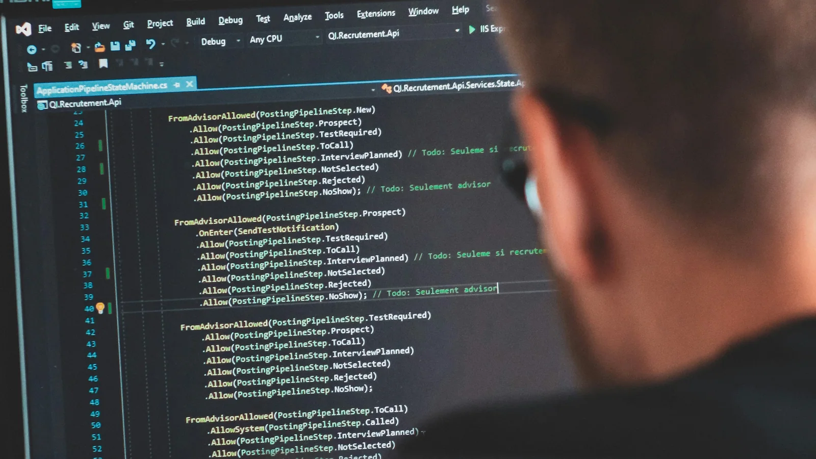 An engineer reviewing inherited application source code on a development screen