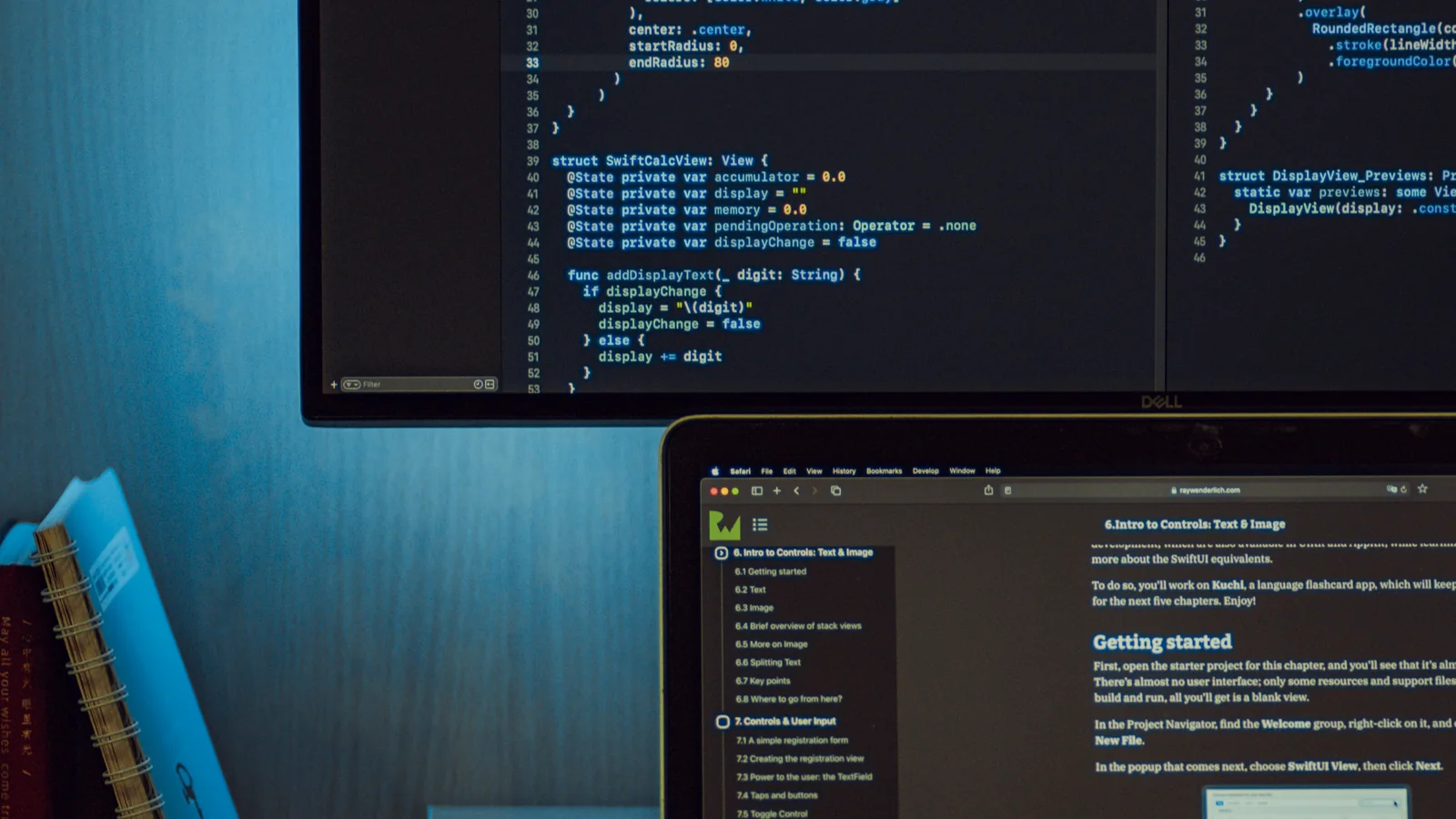 Application code and technical reference material open across two screens